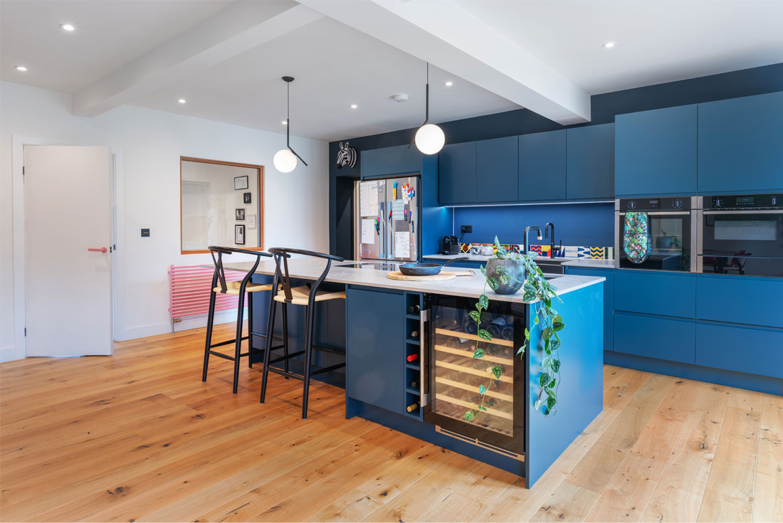 Matt blue modern kitchen with colourful splash back joseph king interiors bristol