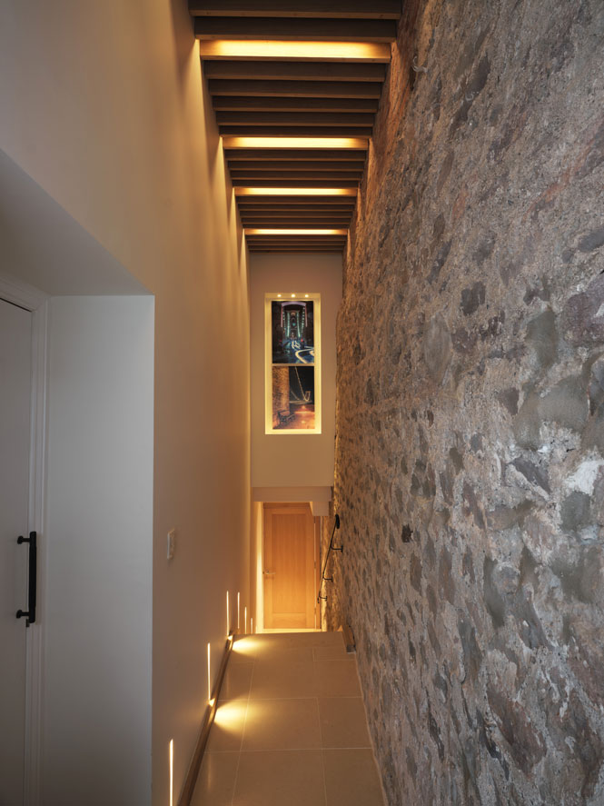 Entrance into home spa with wooden slated ceiling and mood lighting