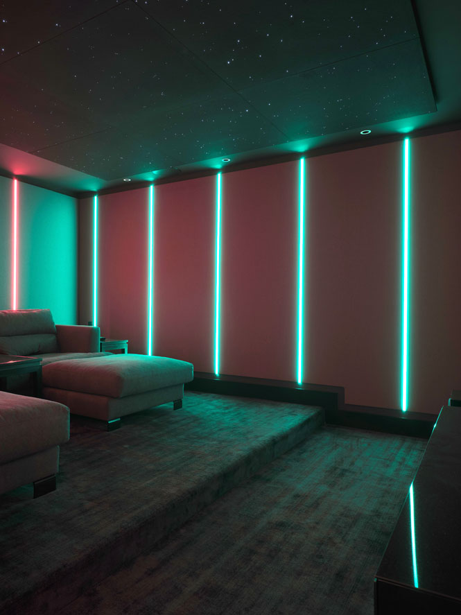 Home cinema with pale blue strip lights and a starry ceiling