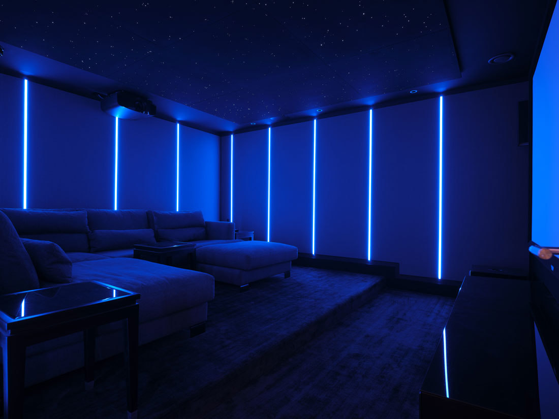 Home cinema with blue strip lights and starry ceiling