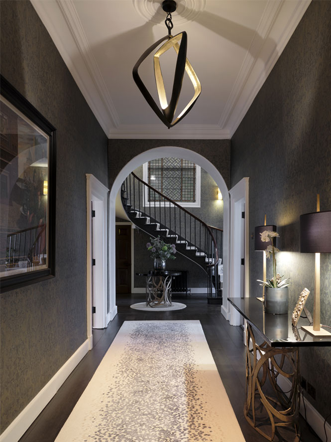 Georgian-Hallway with dark wallpaper and light rugs. Lamps are turned on on a side