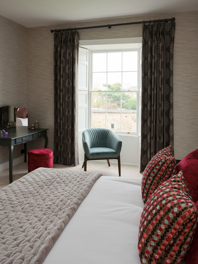 guest bedroom with teal and red accents