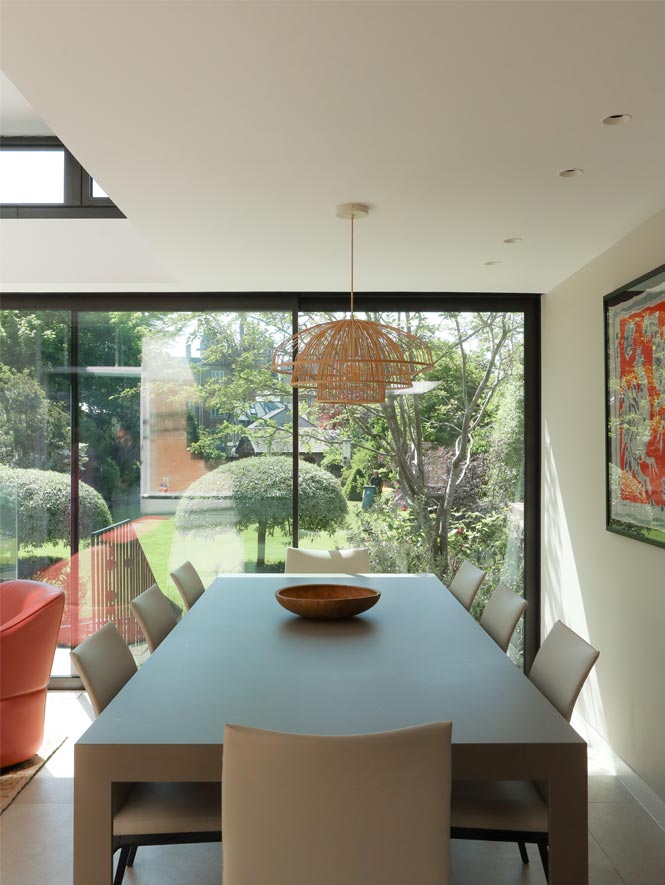 4 modern glazed garden room with coral seating and modern dining table joseph king interiors bristol