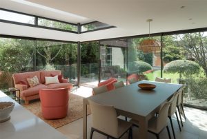 Feature image modern glazed garden room with coral seating joseph king interiors bristol