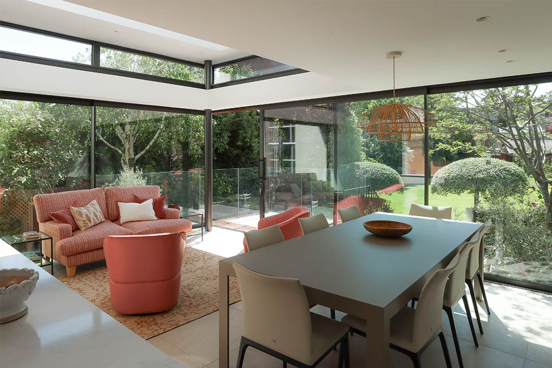 Modern glazed garden room with coral seating joseph king interiors bristol