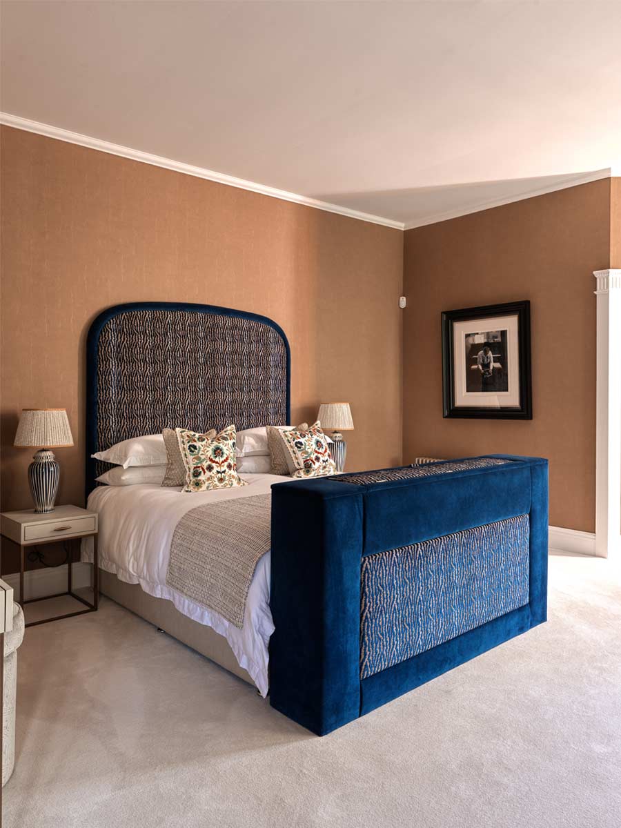 Tall patterened headboard with TV footboard luxury bedroom Joseph King Interiors Bristol
