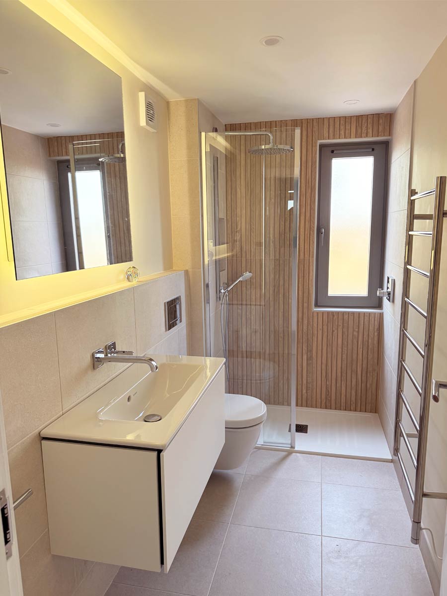 Spa like shower room with wood effect tile at far end